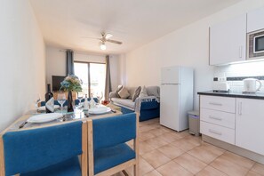 A compact kitchen with white cabinets, a microwave, and a small countertop. - Lovely 1 Bedroom Apartment. Communal Heated Pool (CN)