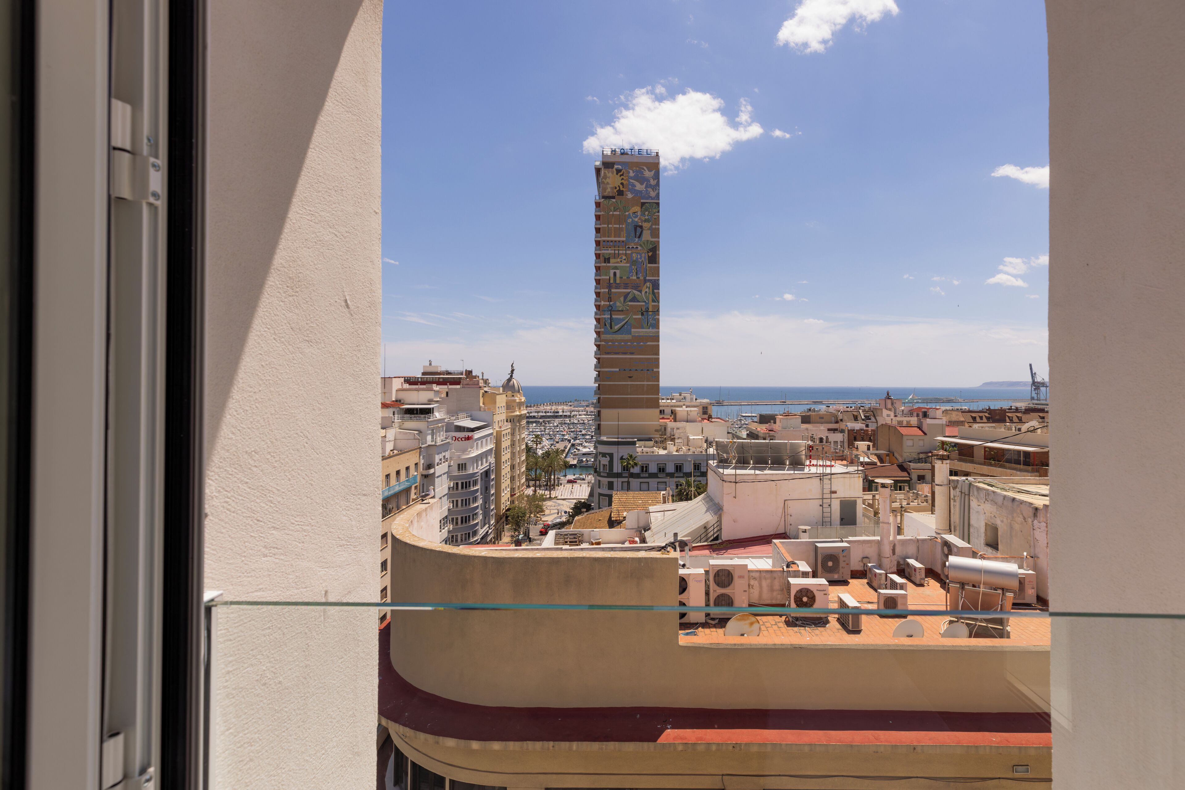 Un hôtel de grande hauteur, doté d’une tour remarquable, de nombreux balcons et offrant une vue sur le paysage urbain.