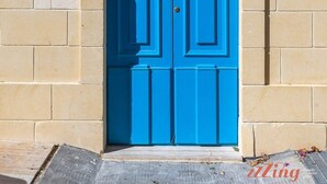 A blue double door with a sign above it reading "The Grove Block A". - Scenic Gozo Apartment & Shared Pool (Ix-Xagħra)