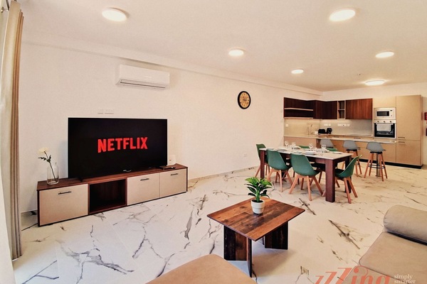 Open plan living room and dining/kitchen area, with AC and Smart TV for a comfortable stay.