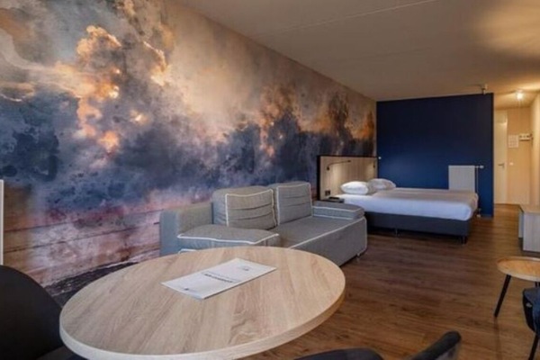 Unwind beneath the dramatic mural in your spacious suite.