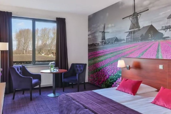 Wake up inspired by vibrant mural views and plush bedding.