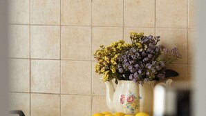 A kitchen counter with a white pitcher of flowers and lemons. - Cozy Studio by the Market Square | Fountain Park (Warszawa)