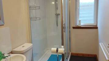 Shower, hair dryer, towels, toilet paper