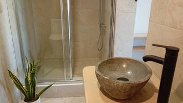 Deluxe Studio, Ocean View | Bathroom | Hair dryer, towels, soap, toilet paper