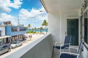 A balcony with a view of the beach and a building across the street. - The Purple Pelican~Beachfront w/ Ocean Balcony~#5 (Fort Lauderdale)