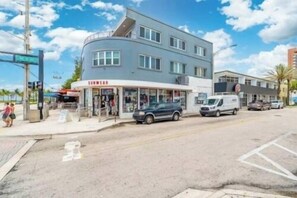 A two-story building with a storefront on the ground floor. - The Purple Pelican~Beachfront w/ Ocean Balcony~#5 (Fort Lauderdale)
