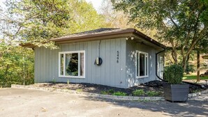 A small, single-story building with a gabled roof, a front porch, and a mailbox.