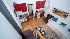 A compact living space with a dining area, kitchenette, and a sofa. - 1 Bedroom. 1 Washroom. 1 Living Room. 1 Double bed, 1 Sofa bed Apartment (Lisbon)