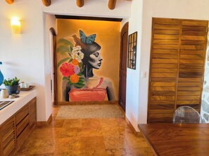 A hallway with a wooden floor, a bench, a wall mural, and a wooden door. - Adults only Luxe 3br La Ropa Oasis w/ ccean view (Zihuatanejo)