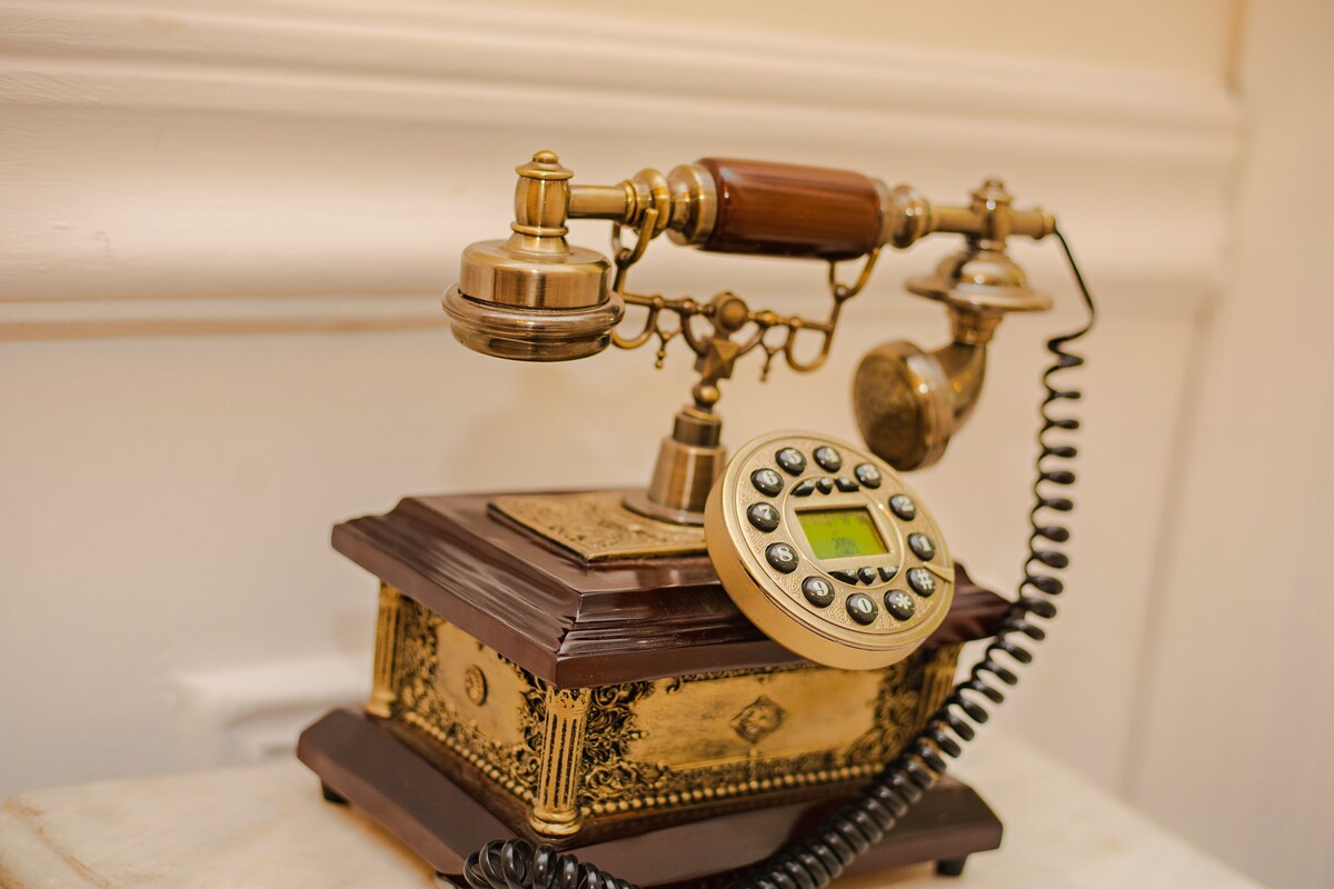 Un teléfono antiguo con un dial giratorio y el auricular.