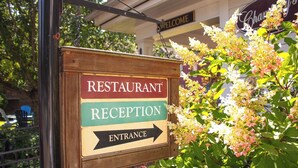 A wooden sign with 'RESTAURANT RECEPTION ENTRANCE' and an arrow pointing right. - Deerfield Inn (Deerfield)