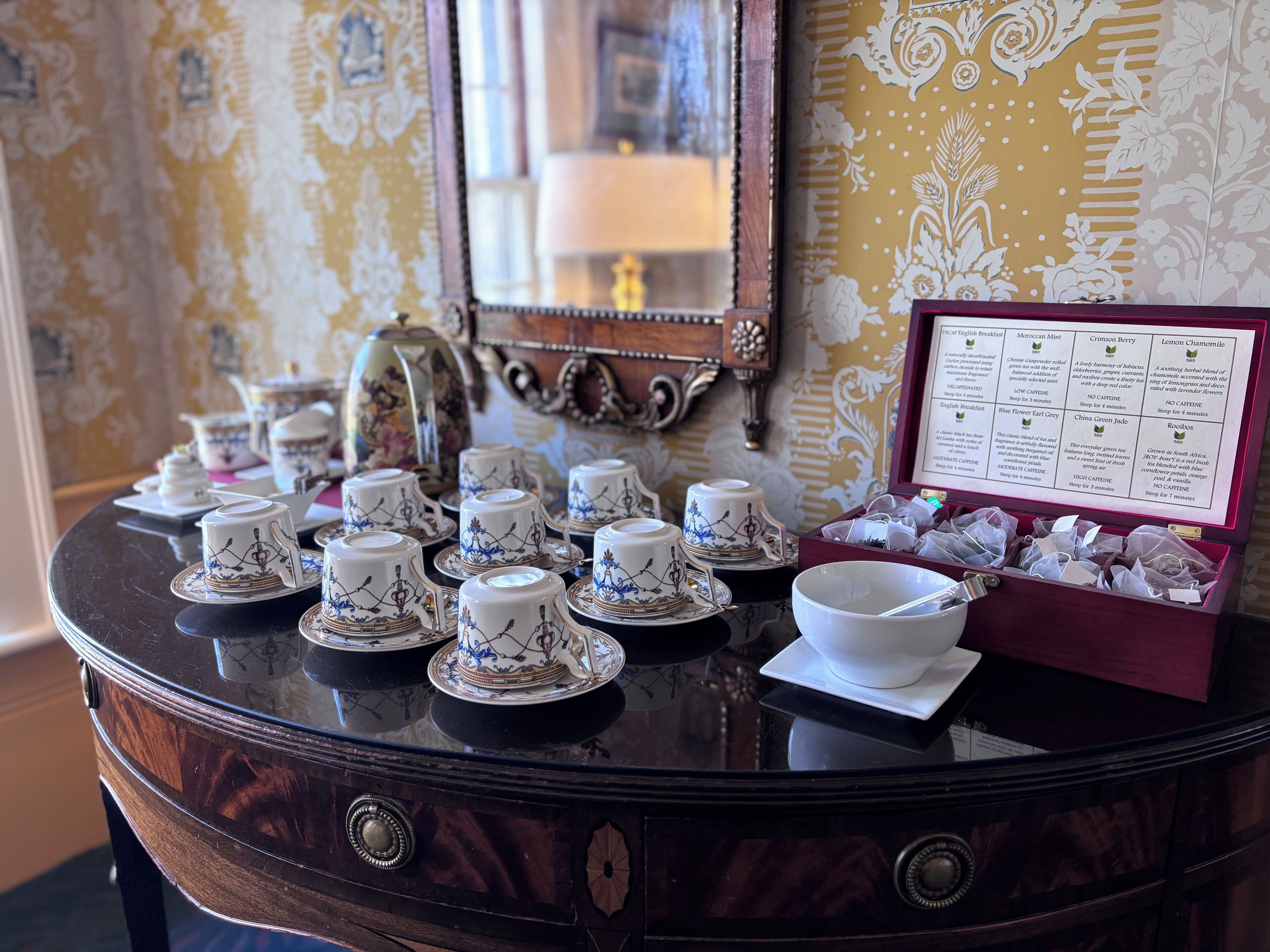 A table with tea sets and a menu detailing tea varieties.
