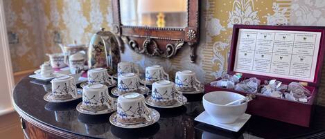 A table with tea sets and a menu detailing tea varieties.