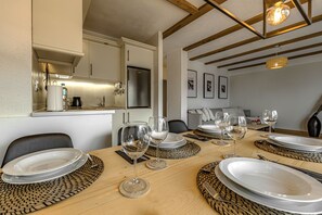 A dining area with a wooden table set for six, including plates, glasses, and cutlery. - Luxury terrace with private BBQ N9 (Puerto de la Cruz)