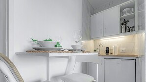A modern kitchen with white cabinetry, a white countertop, and a dishwasher. - Studio with city view N8 (Puerto de la Cruz)