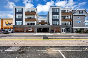 Ein Motel mit Garagenöffnung, Parkplatz und blauem Himmel.
