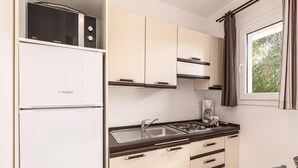 A compact kitchenette with a refrigerator, microwave, and coffee maker. - Spacious Villa Stay for 6, Solenzara (Sari-Solenzara)
