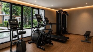 A modern gym with cardio machines, a squat rack, and a bench. - Cozy 1br in Rawai Quiet Area balcony&fast wi-fi (Rawai)