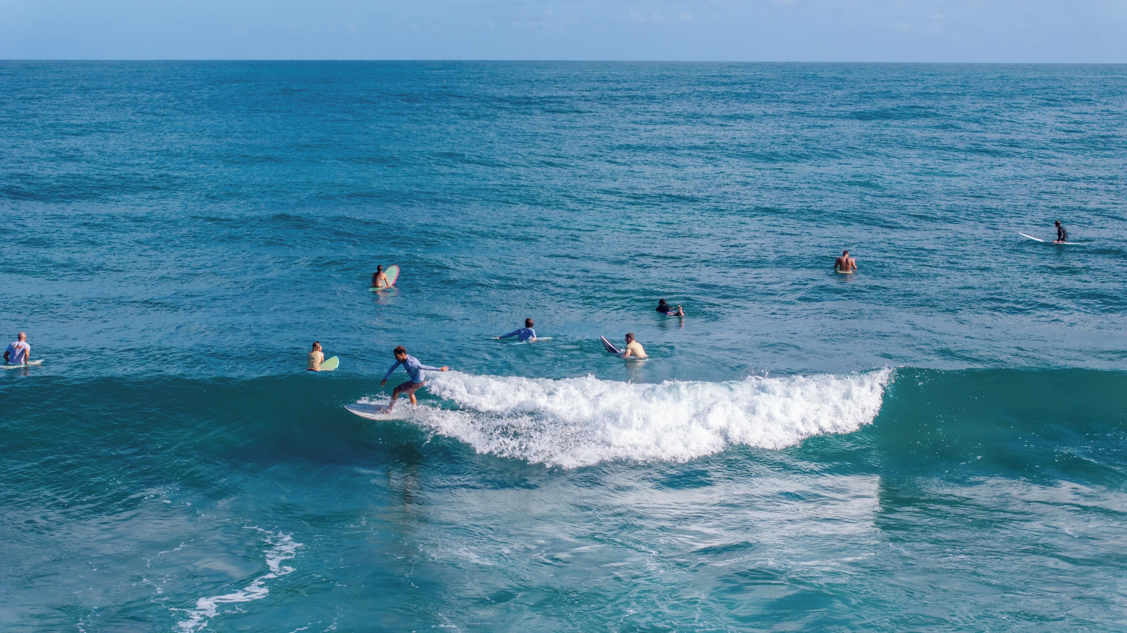 A coastal scene with surfers in the ocean.