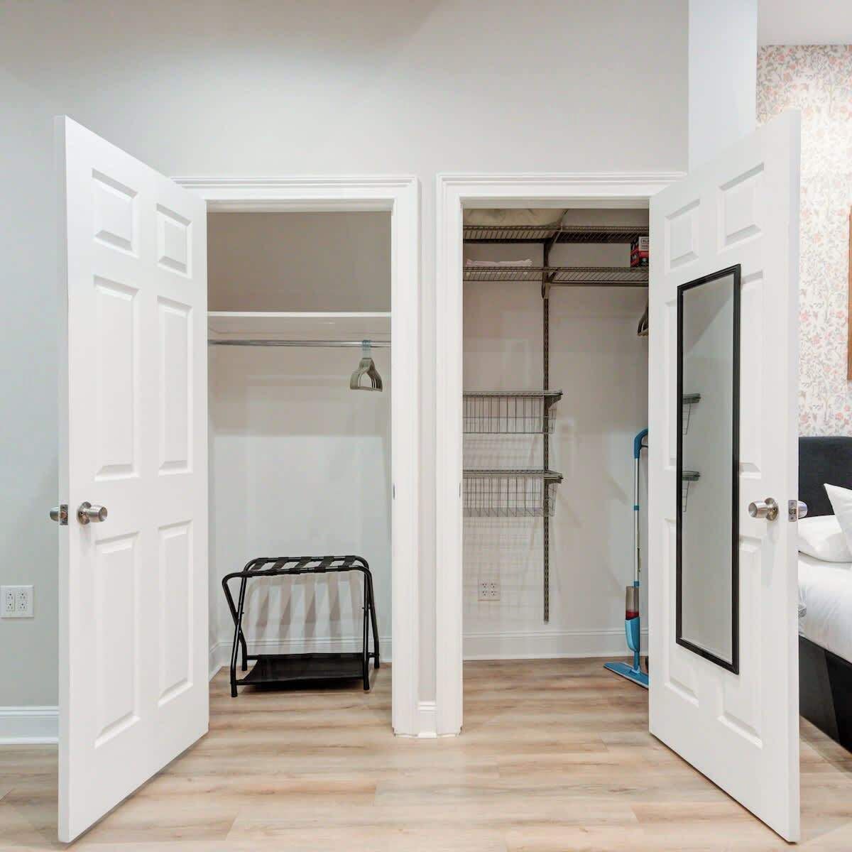 A hallway with open doors leading to a closet and a bathroom.