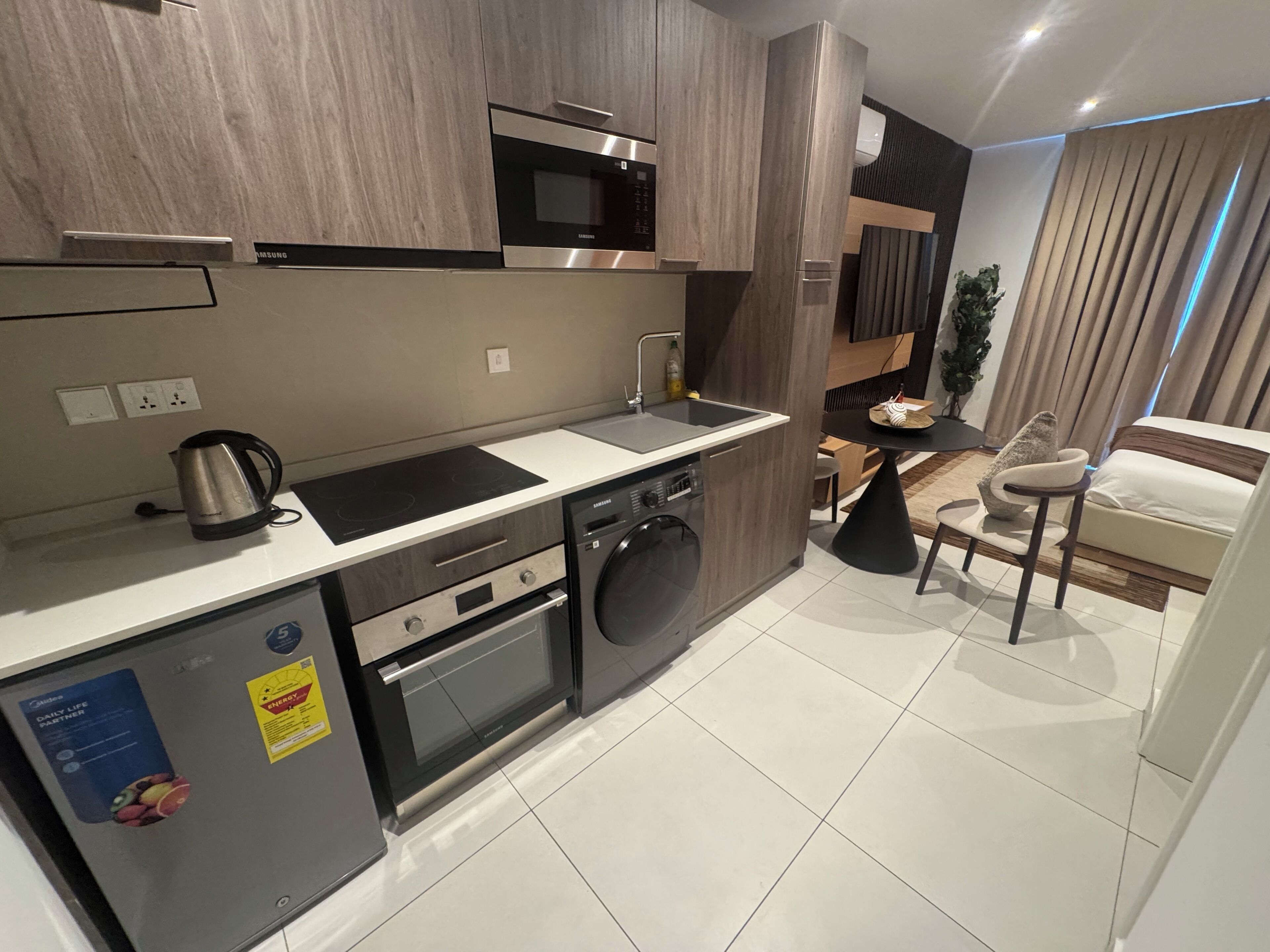 A modern kitchen with stainless steel appliances, a built-in oven, and a microwave.