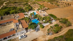 An aerial view of a coastal property with a swimming pool, a beach, and a road leading to the property. - Villa Cotriero Crystal (Gallipoli)