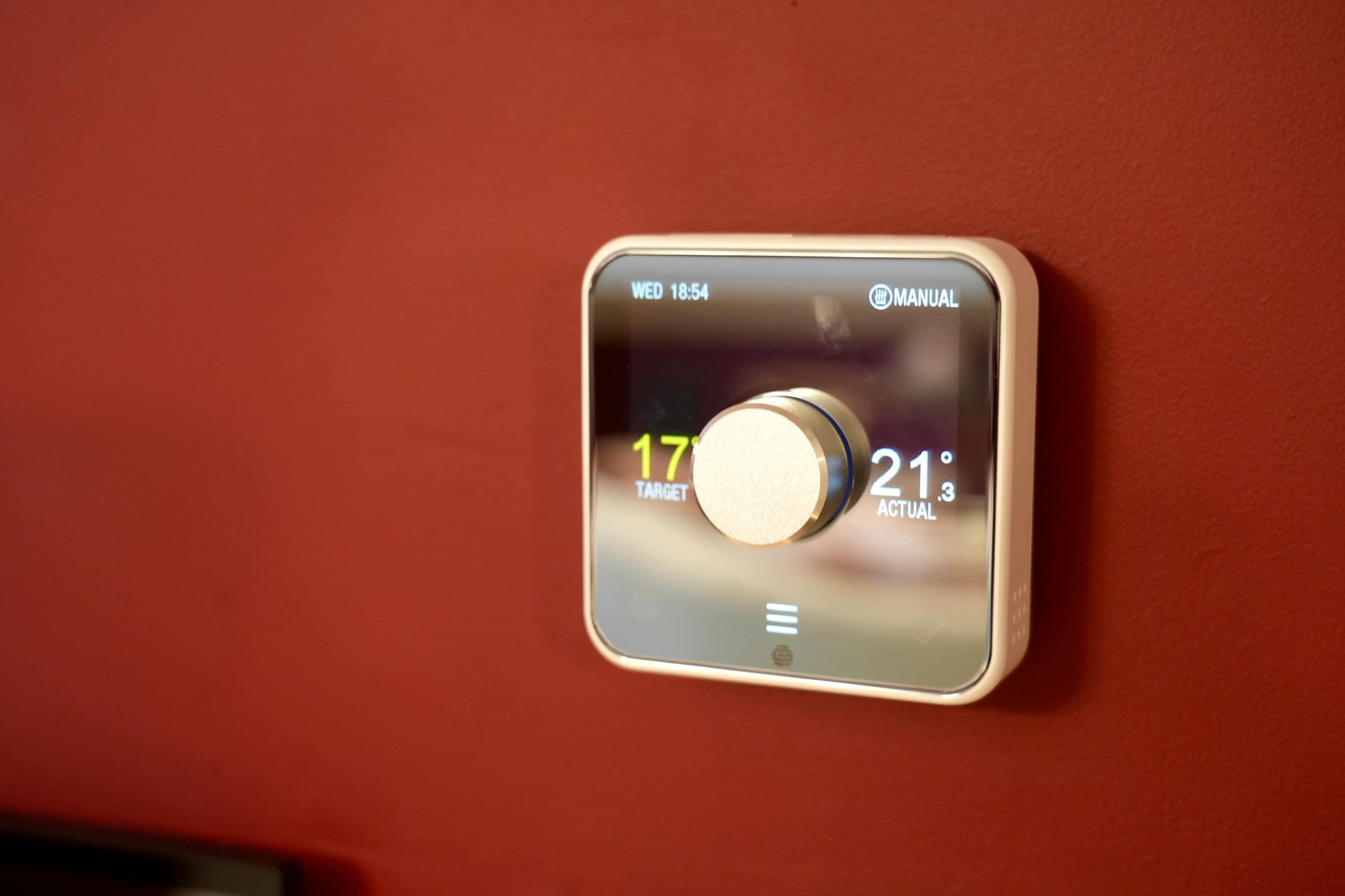 A thermostat with a target temperature setting and current temperature display.