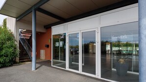 A building with a covered entrance, glass doors, and a sign reading 'Vacanzele'. - Countryside Stay Near Albi Vineyard (Rivieres)