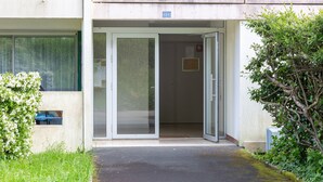 A building entrance with a glass door, a small window, and a number '21' sign. - Apartment “Ty Heol – Balcony and Near Center” with Balcony and Wi-Fi (Quimper)