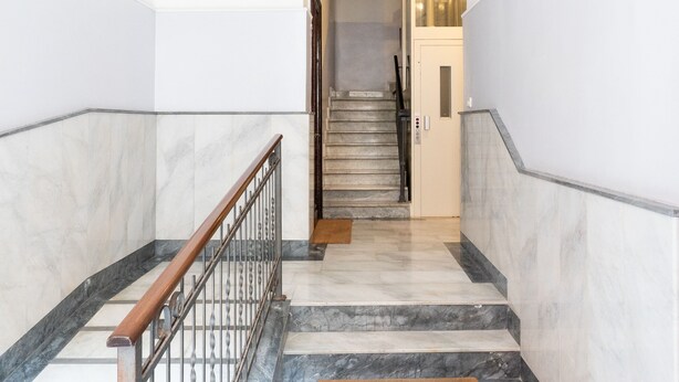 A staircase with marble steps and wooden handrails, leading to a door at the top. - Almarea Suites Levante by Wonderful Italy (Bari)