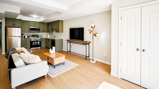 Eine moderne Wohnung mit Küche, Wohnzimmer und Fernseher.