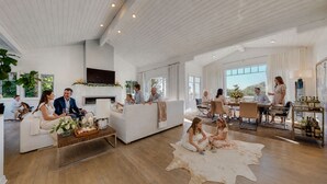 A spacious living area with a fireplace, a dining area, and a bar with a wine display. - Luxury Broad Beach Malibu spacious 3,400 sf retreat one block from the beach (Malibu)