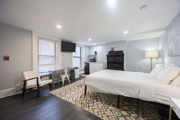 A bedroom with a bed, a desk, a chair, a TV, and a dresser. - Centrally located Stay In Boston's Bay (Boston)