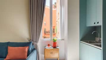 Deluxe Quadruple Room, Balcony | Living area | Printers