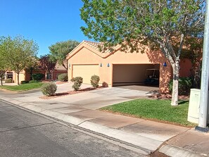 A residential house with a garage, a driveway, and a lawn.