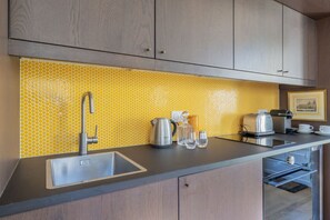 A kitchen with a stainless steel sink, a kettle, a toaster, and a coffee maker on the counter. - Close to the Castle- Soothing and calm garden view (Versailles)