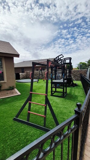 A playground with a climbing structure, swings, and a trampoline. - BIG 5BR Home - Pets OK - RV Parking (Horizon City)