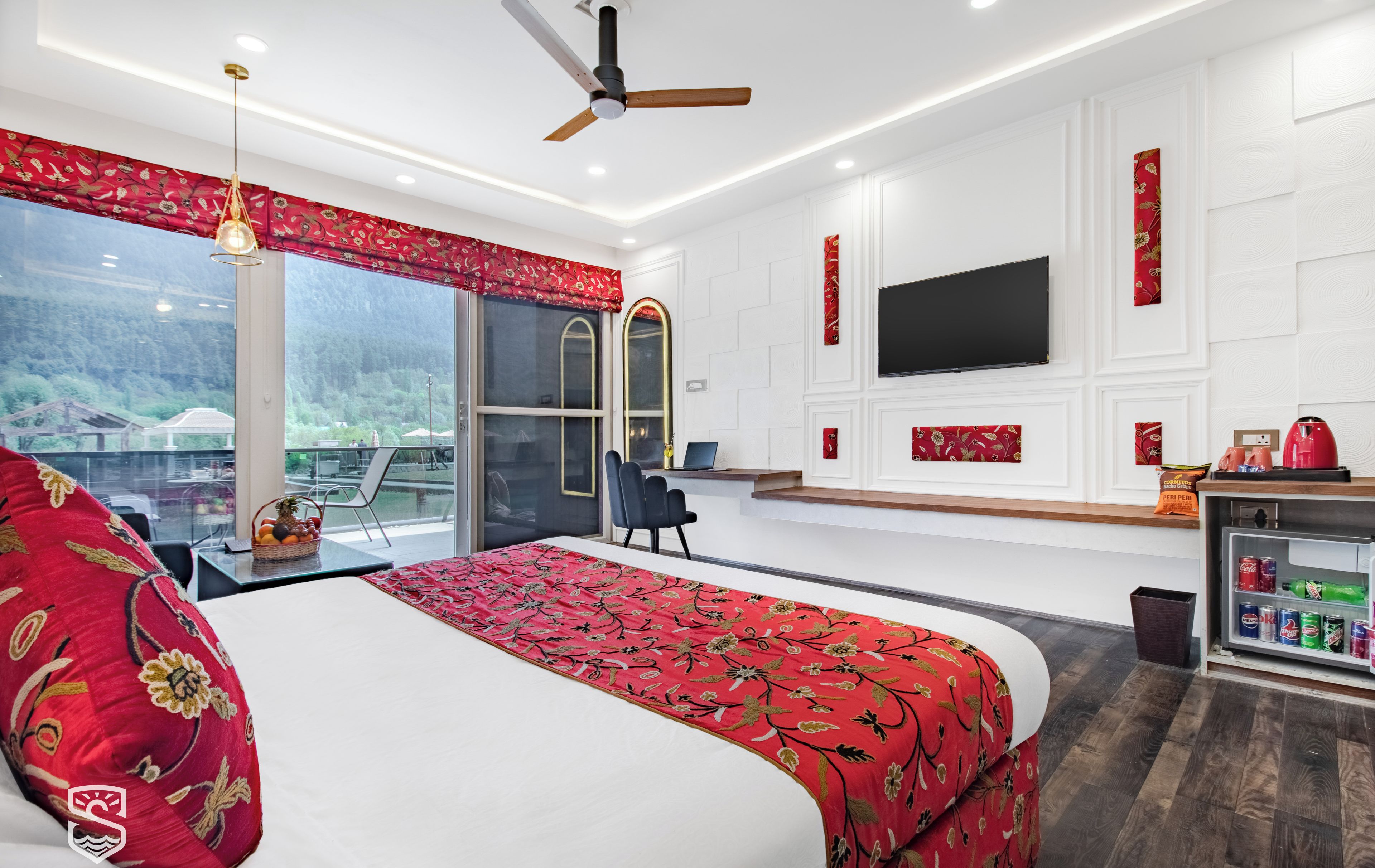 A modern hotel room with a large bed, a TV, a desk with a chair, and a view of the outdoors.