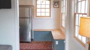 A compact kitchen with a built-in refrigerator, a bench, and a window with a view. - Harriss-James Carriage House Unit B, 0.3 Mi from Historic Downtown (Wilmington)