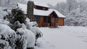 A two-story log cabin with a stone chimney, wooden exterior, and a porch. - B cabin 2-bedroom with AC in charming Blowing Rock (Blowing Rock)