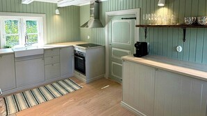 A kitchen with a stove, oven, and a window.