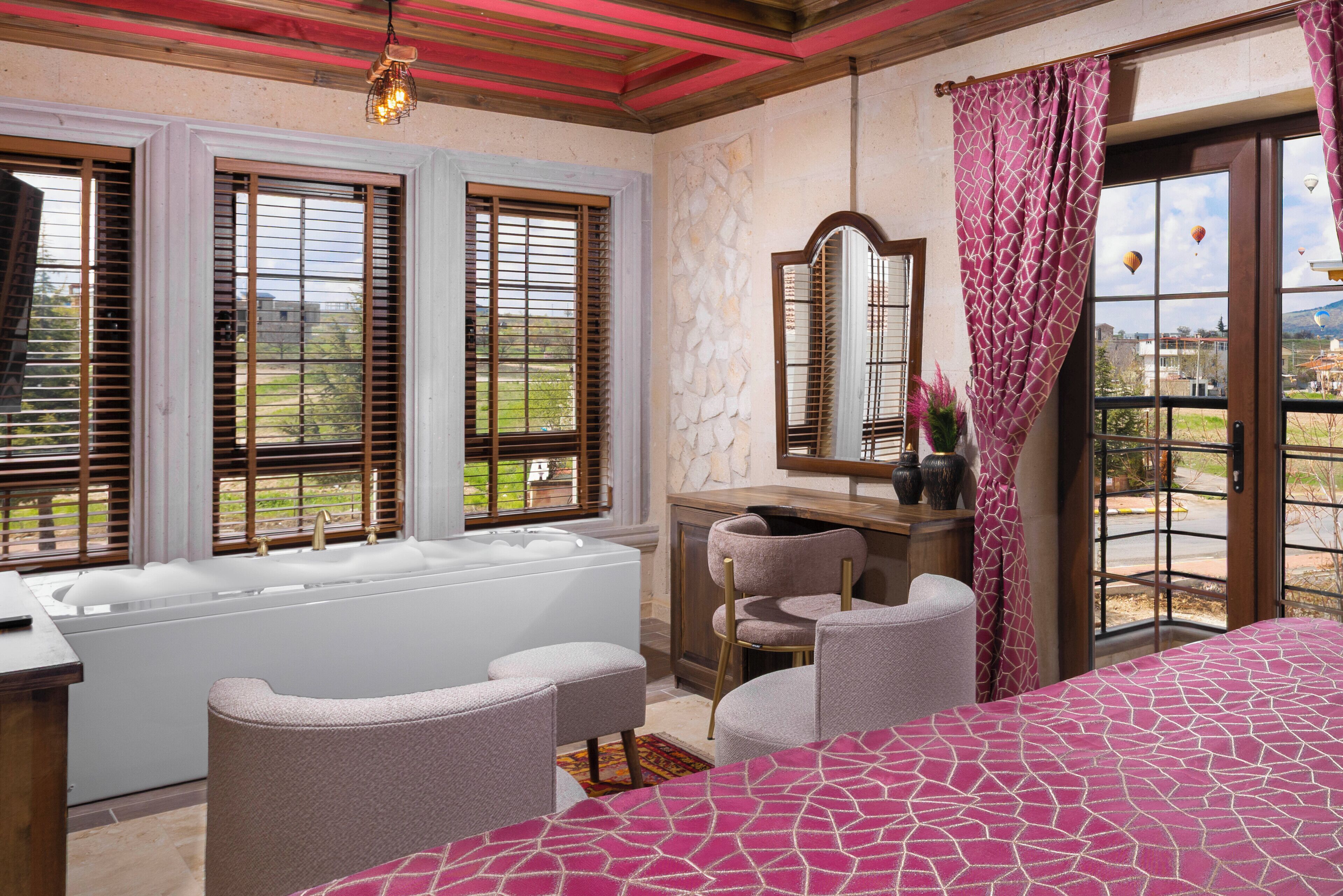 A bedroom with a large bed, a bathtub, and a view of the outside.
