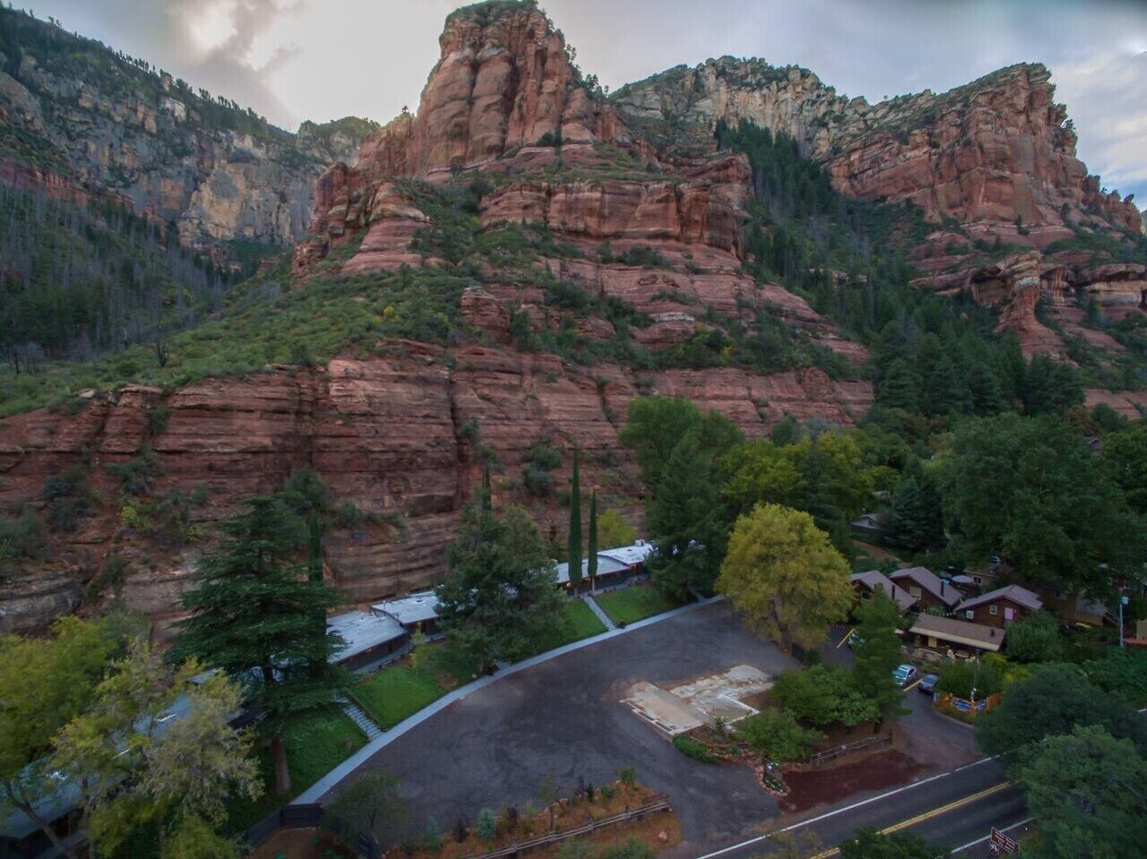 A mountainous landscape with a parking area and buildings.