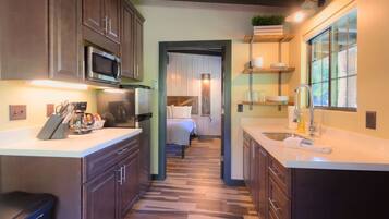 Fridge, microwave, coffee/tea maker, cookware/dishes/utensils