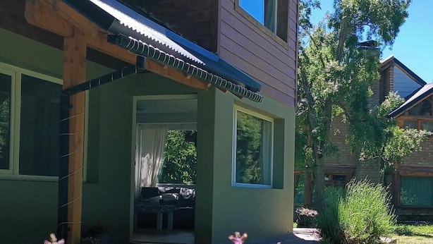 A two-story wooden house with a porch, a window, and a clear sky. - Between Lakes and Mountains • Your Place in Bariloche (San Carlos de Bariloche)