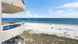A beach view from a balcony with a clear sky and ocean. - Beautiful Beach Front Condo with Breathtaking Views (Orange Beach)