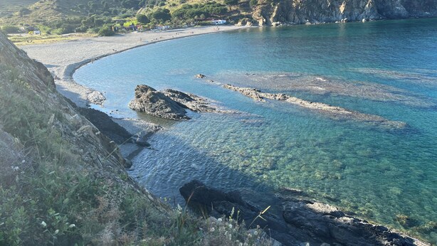A coastal landscape with clear water, rocky shorelines, and a hilly backdrop. - direct seaside rental (Cerbère)
