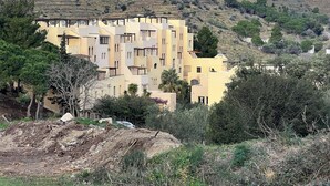 A hillside building with multiple balconies, surrounded by trees and vegetation. - direct seaside rental (Cerbère)