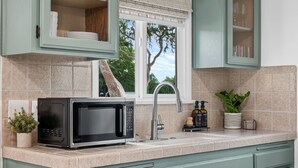 A kitchen with a built-in microwave, a sink, and cabinets. - 10 MIN to Disney - Family Dream Home-King Bed! (Fullerton)